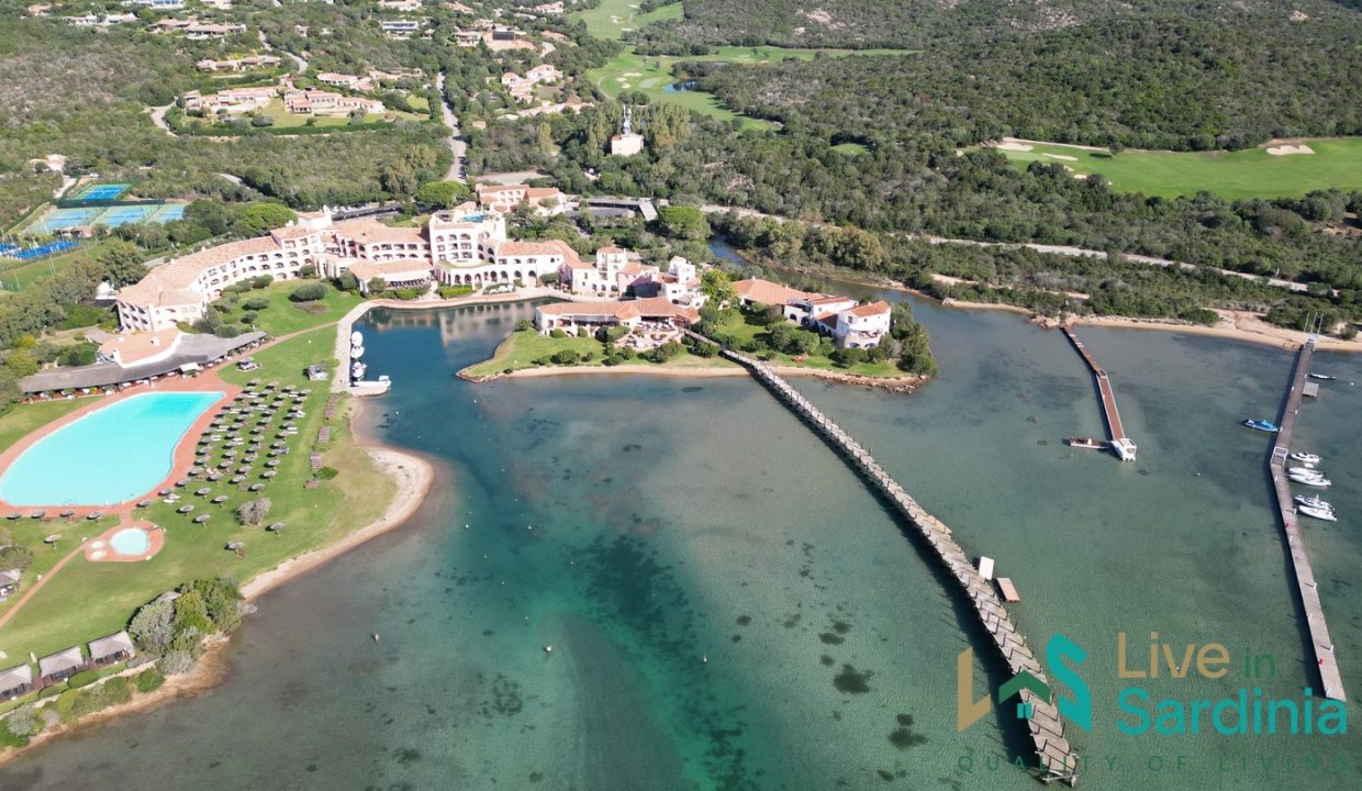 Aeria view on Cala Di Volpe Hotel with cove and pool and golf course on the background