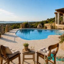 Pool terrace and outdoor living area with sea views at a restored villa in San Pantaleo