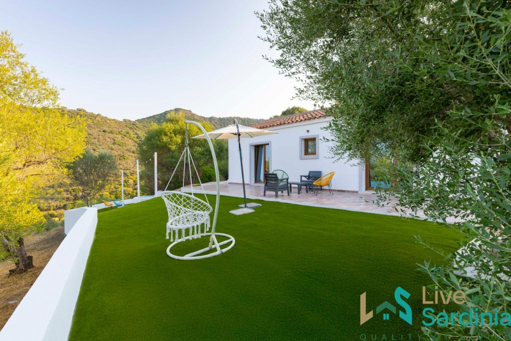 white washed stazzu style home and lawn 