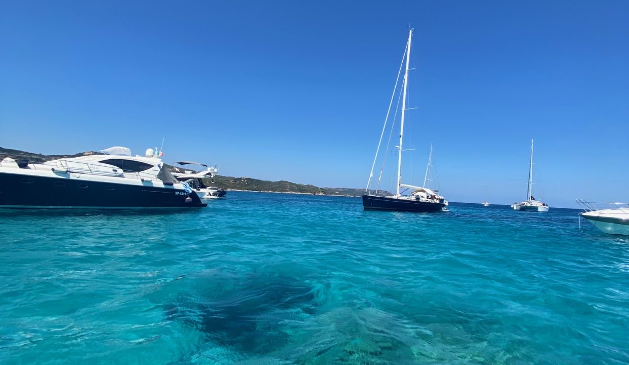 Sardinia clear waters and boats anchored on the La Maddalena Archipelago