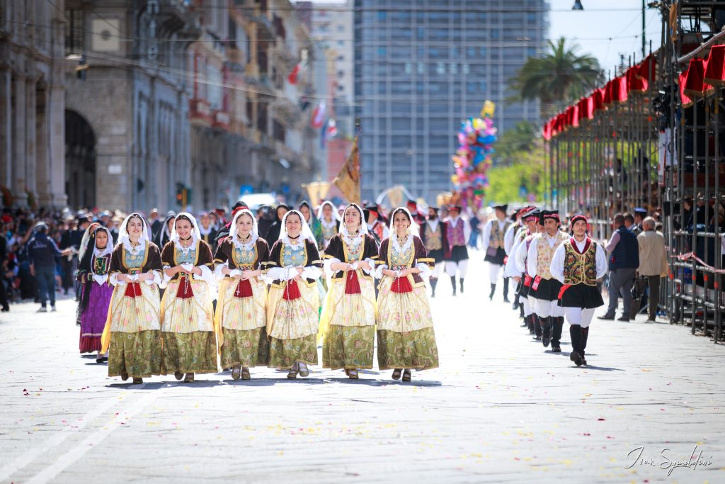 Folk group in San Efisio in Cagliari's  parade wearing colorful traditional vest 