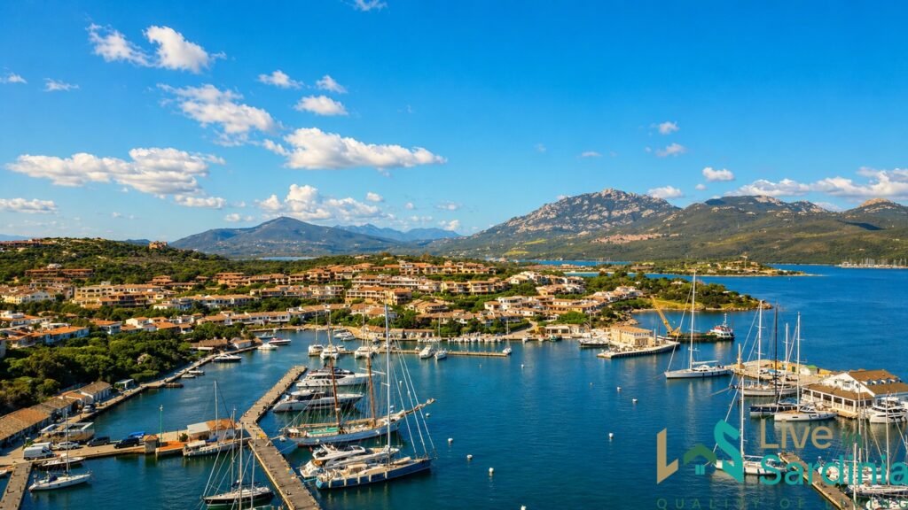 View of luxury yachts and sailing boats in Porto Rotondo marina from a luxury villa veranda in Sardinia