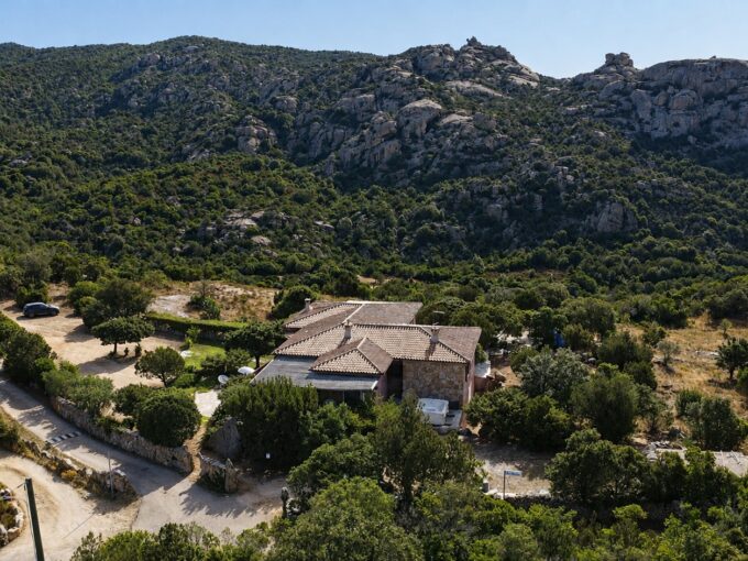 Aerial view of Villa Lu Lisandru surrounded by Gallura countryside and Mediterranean vegetation near Arzachena.